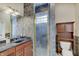 Bathroom with walk-in shower, granite countertop vanity, and tiled walls at 6802 Carters Grove Dr, Noblesville, IN 46062