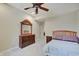 This bedroom has an ornamental wooden dresser and a wooden bed frame with purple accented pillows at 6802 Carters Grove Dr, Noblesville, IN 46062