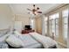 Bedroom with a ceiling fan, dresser with TV, and plenty of natural light from bright windows at 6802 Carters Grove Dr, Noblesville, IN 46062