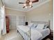 Bedroom boasts a decorative wrought iron bed frame, ceiling fan, and neutral decor at 6802 Carters Grove Dr, Noblesville, IN 46062