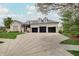 Expansive driveway leading to a brick home with three-car garage and dormer windows at 6802 Carters Grove Dr, Noblesville, IN 46062