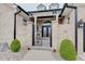 Close-up of the beautiful brick entryway with a wrought iron gate and manicured bushes at 6802 Carters Grove Dr, Noblesville, IN 46062