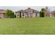 Expansive residence boasts a pristine lawn, perfectly manicured landscaping, and a classic facade at 6802 Carters Grove Dr, Noblesville, IN 46062