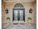 Elegant double front doors with decorative glass and sconces, enhancing curb appeal at 6802 Carters Grove Dr, Noblesville, IN 46062
