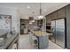 Spacious kitchen with stainless steel appliances, granite counters, island seating, and decorative lighting at 6802 Carters Grove Dr, Noblesville, IN 46062