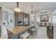 Open kitchen features granite island with seating, stainless appliances, and an open plan to dining and living areas at 6802 Carters Grove Dr, Noblesville, IN 46062