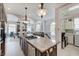 Bright kitchen with granite island and open layout to the living and dining area, as well as a laundry room at 6802 Carters Grove Dr, Noblesville, IN 46062