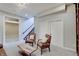 Comfortable living area with cozy seating, neutral tones, and a view of the staircase creates a serene retreat at 6802 Carters Grove Dr, Noblesville, IN 46062