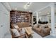 Cozy living room with custom built-in shelving, warm lighting, and comfortable seating for relaxation and entertainment at 6802 Carters Grove Dr, Noblesville, IN 46062