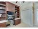 Home office with custom desk, built in shelving, and a light and neutral color scheme at 6802 Carters Grove Dr, Noblesville, IN 46062