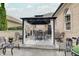 Covered outdoor patio featuring elegant lighting, comfortable seating, and a stylish bar area for entertaining at 6802 Carters Grove Dr, Noblesville, IN 46062