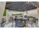 Covered outdoor patio featuring elegant lighting, comfortable seating, and a stylish bar area for entertaining at 6802 Carters Grove Dr, Noblesville, IN 46062