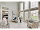 Bright sitting area with large windows, comfortable seating, and view to the exterior at 6802 Carters Grove Dr, Noblesville, IN 46062