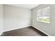 Bedroom featuring wood-look flooring, a window, and neutral paint at 693 Cembra Dr, Greenwood, IN 46143