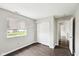 Bedroom featuring closet with bifold doors, wood-look flooring, a window, and neutral paint at 693 Cembra Dr, Greenwood, IN 46143