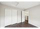 Bedroom featuring closet with bifold doors, wood-look flooring, and a door leading to the hallway at 693 Cembra Dr, Greenwood, IN 46143