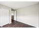 Bedroom with hardwood floors, neutral paint, a window, and a closet with bifold doors at 693 Cembra Dr, Greenwood, IN 46143