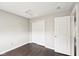 Bedroom featuring closet with bifold doors, wood-look flooring, and two doors at 693 Cembra Dr, Greenwood, IN 46143