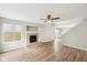 Bright living room with hardwood floors, a ceiling fan, and a cozy fireplace at 693 Cembra Dr, Greenwood, IN 46143