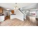 Open floor plan with hardwood floors connecting the kitchen, dining, and living areas at 693 Cembra Dr, Greenwood, IN 46143