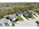 An aerial view showcases a home with solar panels, surrounded by neighboring houses and lush greenery at 7010 Beargrass Ct, Indianapolis, IN 46241