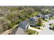 Aerial view of a suburban home near a pond, showcasing the property's setting and well-manicured lawn at 7010 Beargrass Ct, Indianapolis, IN 46241