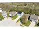Aerial view showcases a house with solar panels nestled in a residential area with surrounding homes and greenery at 7010 Beargrass Ct, Indianapolis, IN 46241