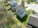 Aerial view of home with solar panels in a neighborhood with mature trees at 7010 Beargrass Ct, Indianapolis, IN 46241