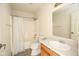 Functional bathroom with a shower-tub combo, light fixtures, and white tile at 7010 Beargrass Ct, Indianapolis, IN 46241