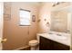 Cozy half bathroom features a vanity, toilet, mirror, and towel rack at 7010 Beargrass Ct, Indianapolis, IN 46241