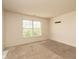 Bright bedroom featuring neutral carpet, a large window, and painted walls at 7010 Beargrass Ct, Indianapolis, IN 46241