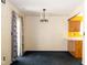 Open dining room with modern chandelier and access to the kitchen at 7010 Beargrass Ct, Indianapolis, IN 46241