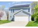 Charming two-story home with vinyl siding, solar panels, and a well-manicured lawn at 7010 Beargrass Ct, Indianapolis, IN 46241