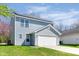 Exterior of home with attached garage, solar panels, and vinyl siding at 7010 Beargrass Ct, Indianapolis, IN 46241