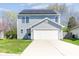 Charming home featuring solar panels, a two-car garage, and well-maintained landscaping at 7010 Beargrass Ct, Indianapolis, IN 46241