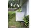 A side backyard showcasing well-maintained lawn and a new white fence, accented by vibrant ferns at 7144 Lockwood Ln, Indianapolis, IN 46217