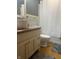 Bathroom featuring a light wood vanity, a standard white toilet, and a bathtub shower with a white curtain at 7144 Lockwood Ln, Indianapolis, IN 46217