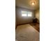Spacious bedroom with hardwood floors, a window, and light-colored walls, offering a comfortable and inviting space at 7144 Lockwood Ln, Indianapolis, IN 46217
