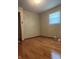 This bedroom offers hardwood flooring and a window that allows natural light at 7144 Lockwood Ln, Indianapolis, IN 46217