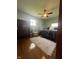 This bedroom features a ceiling fan, a rug, chair, and queen bed at 7144 Lockwood Ln, Indianapolis, IN 46217