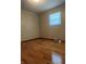 Bedroom with hardwood floors, light colored walls, and a window with blinds at 7144 Lockwood Ln, Indianapolis, IN 46217