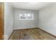 A modest bedroom features hardwood floors and a window at 7144 Lockwood Ln, Indianapolis, IN 46217