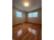 Bedroom with hardwood floors, a window with blinds, and light colored walls at 7144 Lockwood Ln, Indianapolis, IN 46217