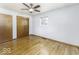 A bright bedroom features hardwood floors and a classic ceiling fan at 7144 Lockwood Ln, Indianapolis, IN 46217
