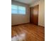 Bedroom with hardwood floors, a window with blinds, and a closet at 7144 Lockwood Ln, Indianapolis, IN 46217
