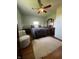This bedroom features a ceiling fan, a rug, chair, and queen bed at 7144 Lockwood Ln, Indianapolis, IN 46217
