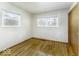 This simple bedroom offers hardwood floors and natural light through two windows at 7144 Lockwood Ln, Indianapolis, IN 46217