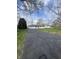 Long driveway leading to a charming one-story home with brick facade, attached garage at 7144 Lockwood Ln, Indianapolis, IN 46217