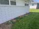Exterior base of house with flowerbed of red and yellow tulips at 7144 Lockwood Ln, Indianapolis, IN 46217