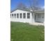 The home's exterior showcases a sunroom, painted white with a covered porch for enjoying the outdoors at 7144 Lockwood Ln, Indianapolis, IN 46217